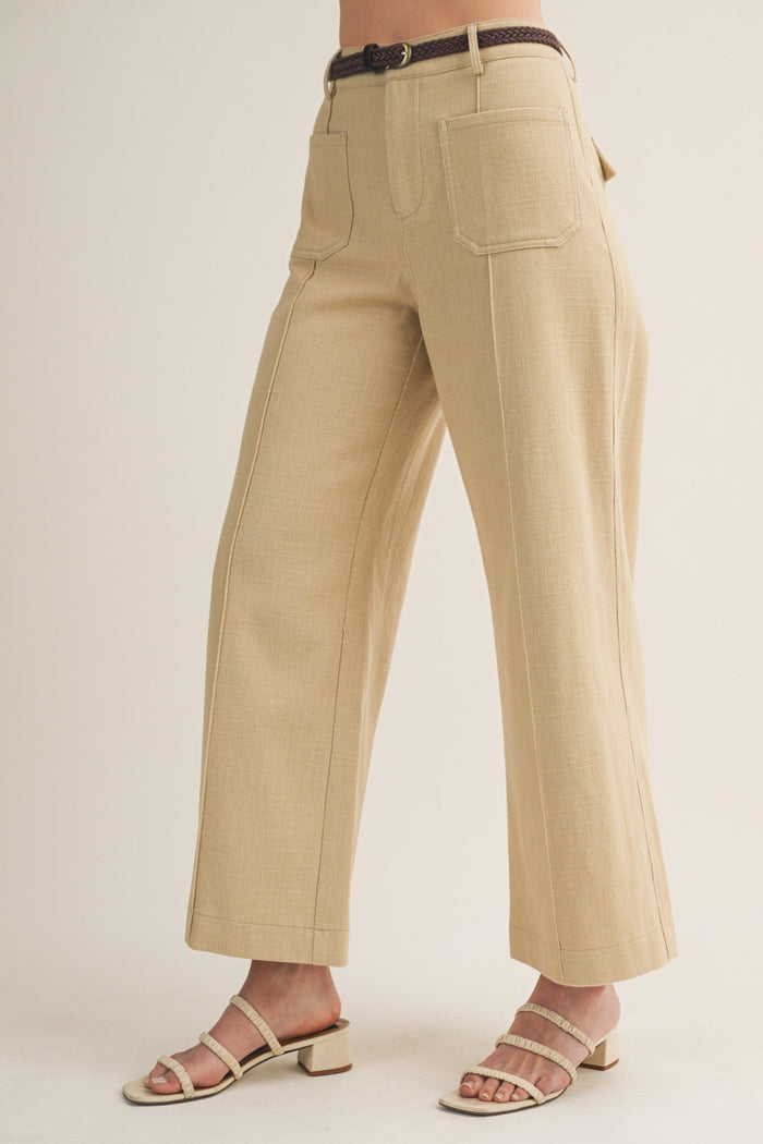 Khaki wide-leg pants with patch pockets, contrasting topstitching, and brown woven belt at waist.