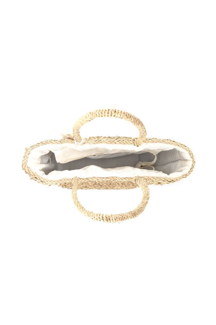 Natural woven straw tote bag with rope handles, shown open to display cream and gray interior lining.