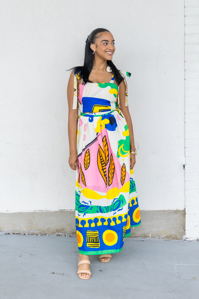 Sleeveless top with colorful abstract geometric and leaf print in pink, blue, yellow, and green on white background.