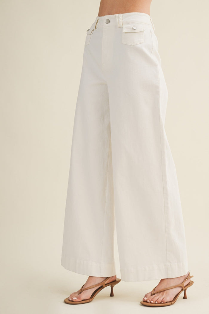 White wide-leg pants worn by a person on a beige background