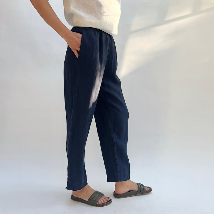 3/4 front view of person wearing navy linen pants