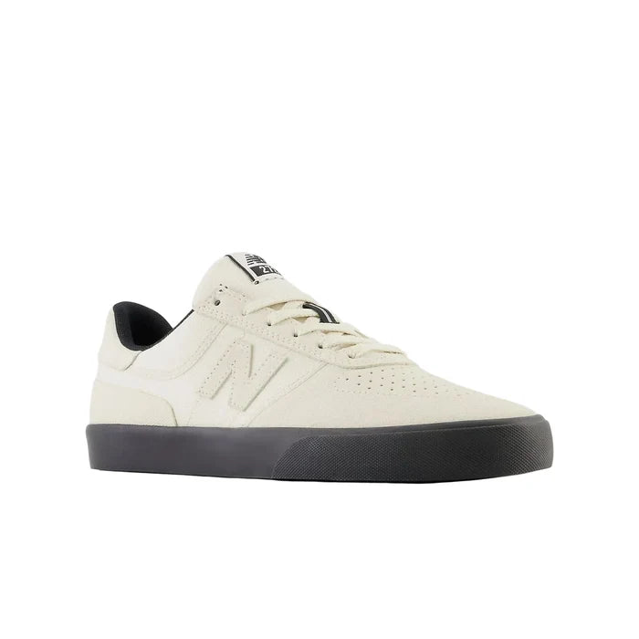 White sneaker with black sole on a white background
