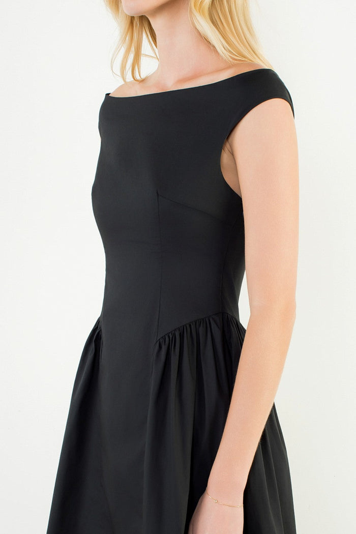 Black dress worn by a person on a white background