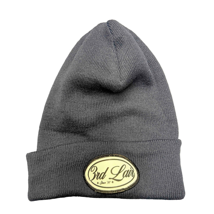 Navy beanie with a logo on a gray surface