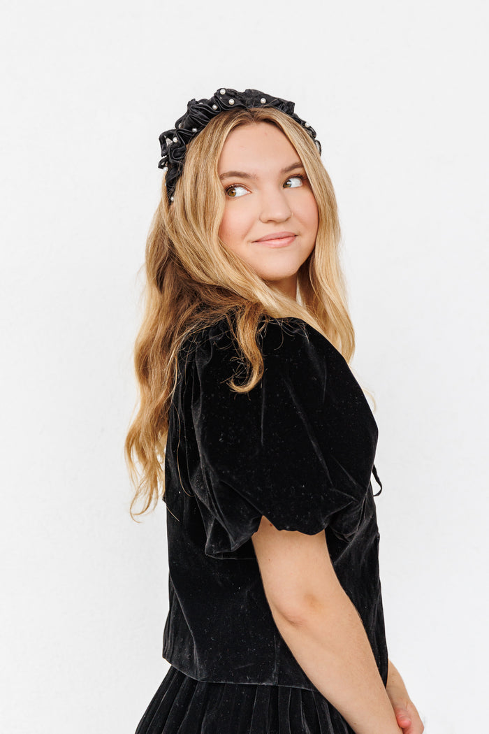 Black velvet top with short puffed sleeves and gathered waistline.