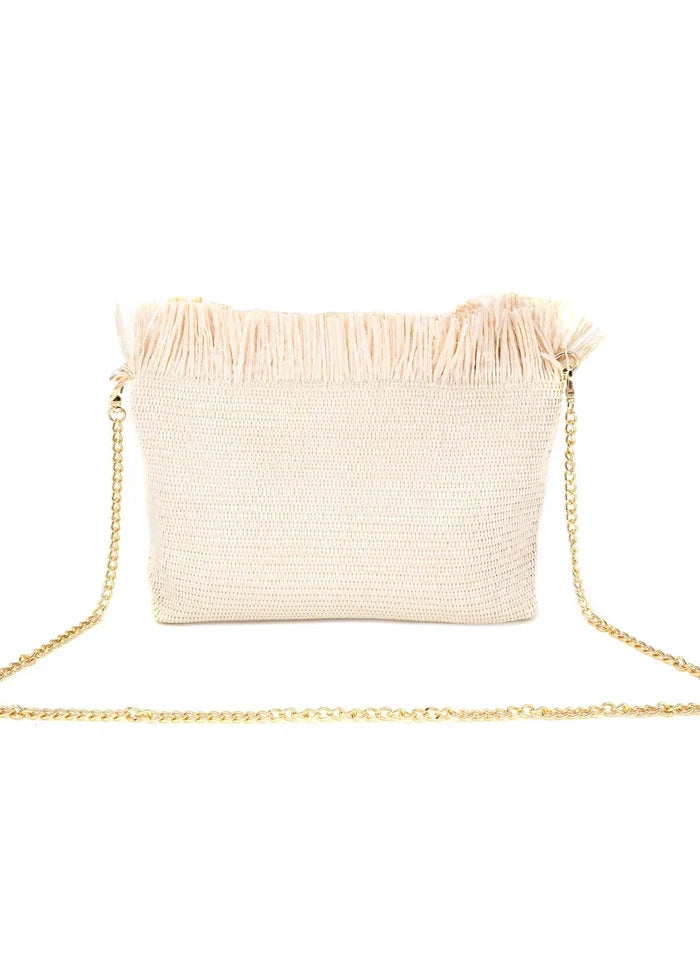 Cream straw clutch with fringe trim along the top edge and gold chain shoulder strap.
