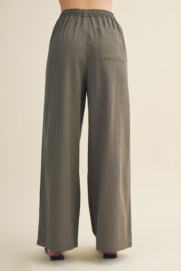 Gray wide-leg pants on a beige background