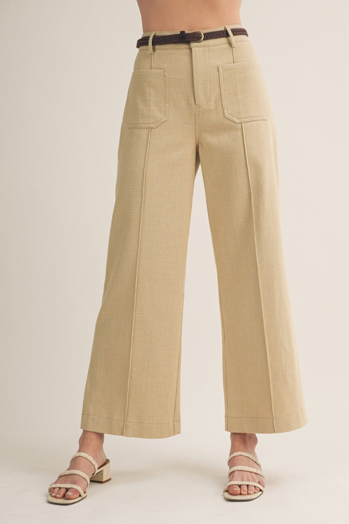 Khaki wide-leg pants with front pockets and belt worn at waist.
