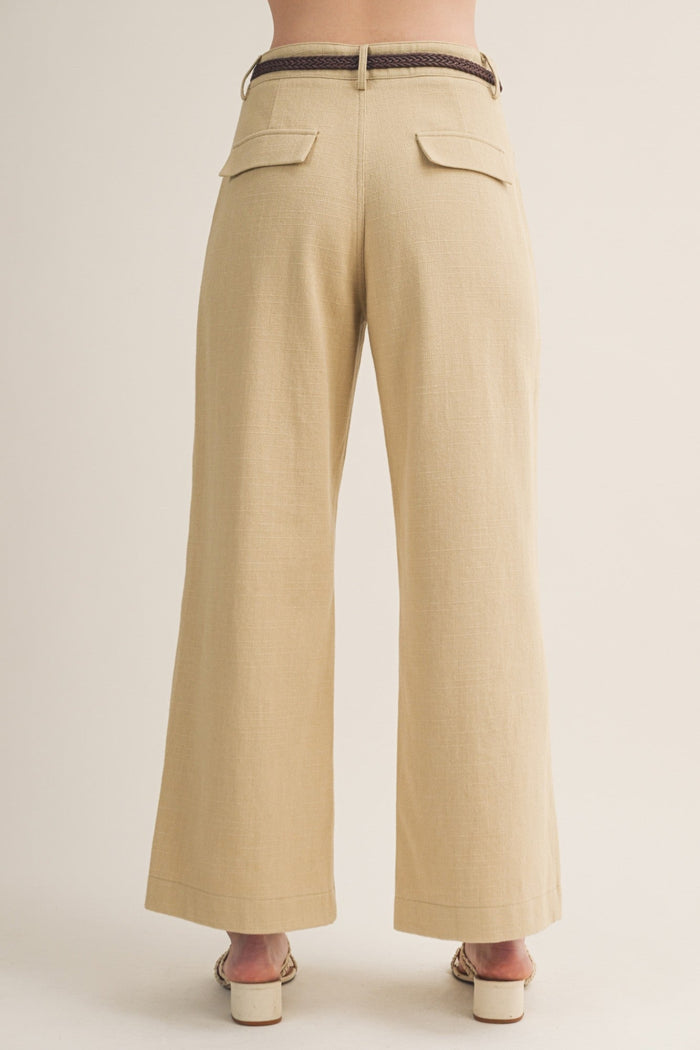 Khaki wide-leg pants with woven belt, rear flap pockets, and center seam detail, back view.