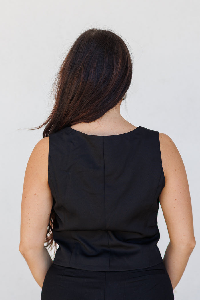 Black sleeveless suit vest with back seam detail, shown from rear view on model.