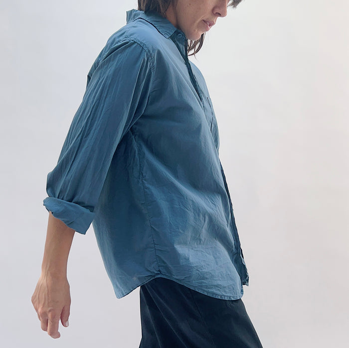 Side view of the Alix Top in Moonlit Ocean showing the relaxed boxy silhouette, rolled sleeves, and curved hem