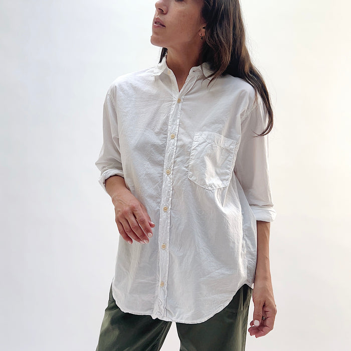 Alix Top in White — front view, oversized button-down with chest pocket and long sleeves, styled with olive trousers