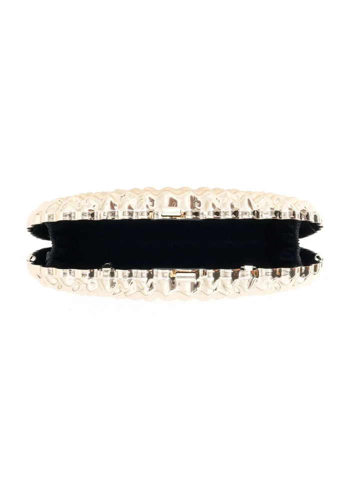 Gold clutch with quilted metal exterior, black velvet interior, and metal clasp closure shown open.