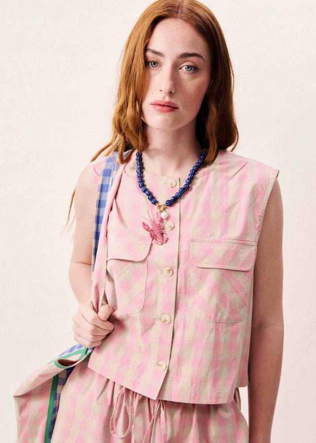 Pink sleeveless vest with beige striped pattern, button front, and chest pockets.