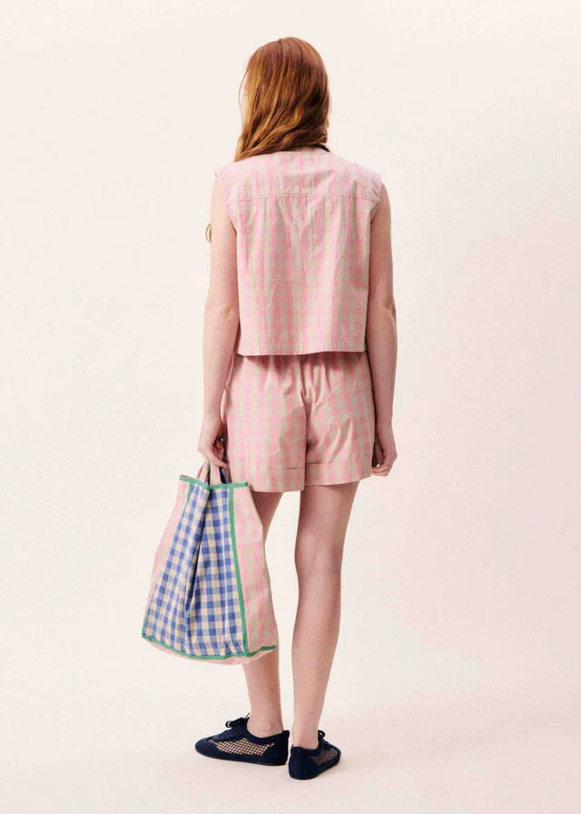 Pink sleeveless vest with cropped length, shown from back on model wearing matching shorts.