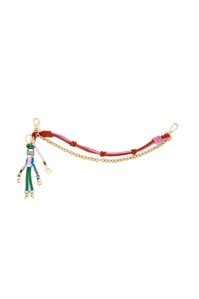 Gold chain bag charm with red and pink leather straps, colorful beaded tassel, and gold hardware accents.