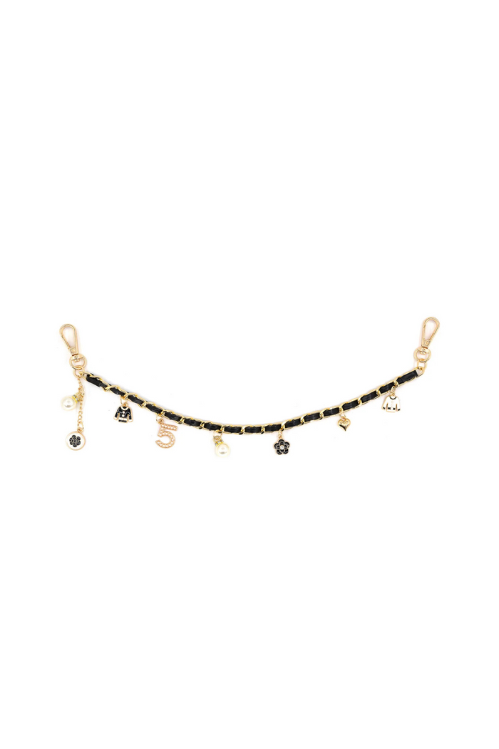 Black and gold chain bag charm with multiple small metal pendants and gold clasp hooks on each end.