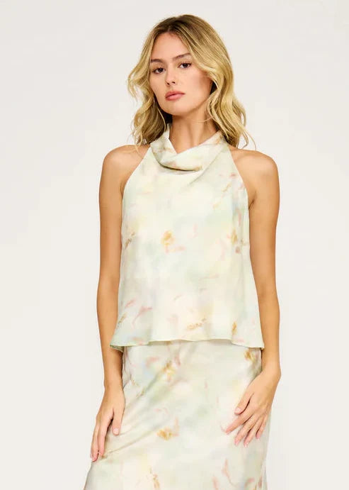 Sleeveless cowl neck top in cream tie-dye with draped neckline and layered silhouette.