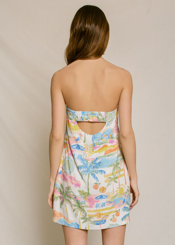 Strapless mini dress with tropical print featuring palm trees, beaches, and citrus fruits in multicolor on cream background.