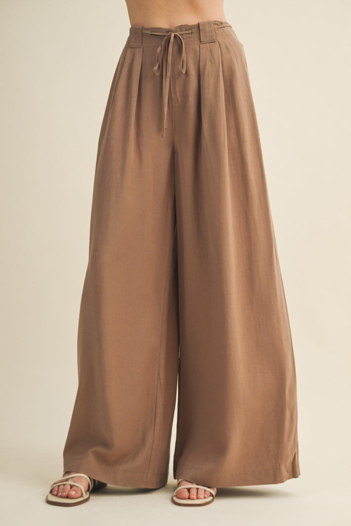 Brown wide-leg pants on a beige background