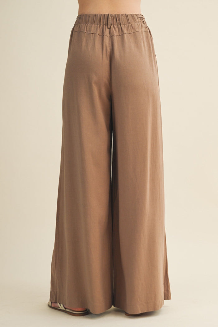 Brown wide-leg pants on a beige background