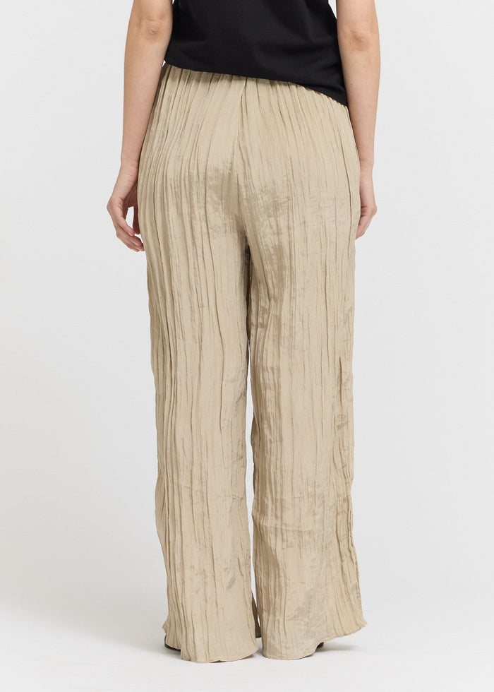 Beige wide-leg pants worn by a person on a white background
