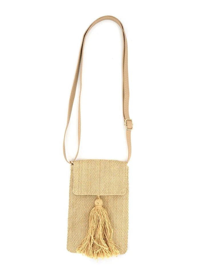 Gold woven crossbody bag with long shoulder strap, flap closure, and tassel accent.