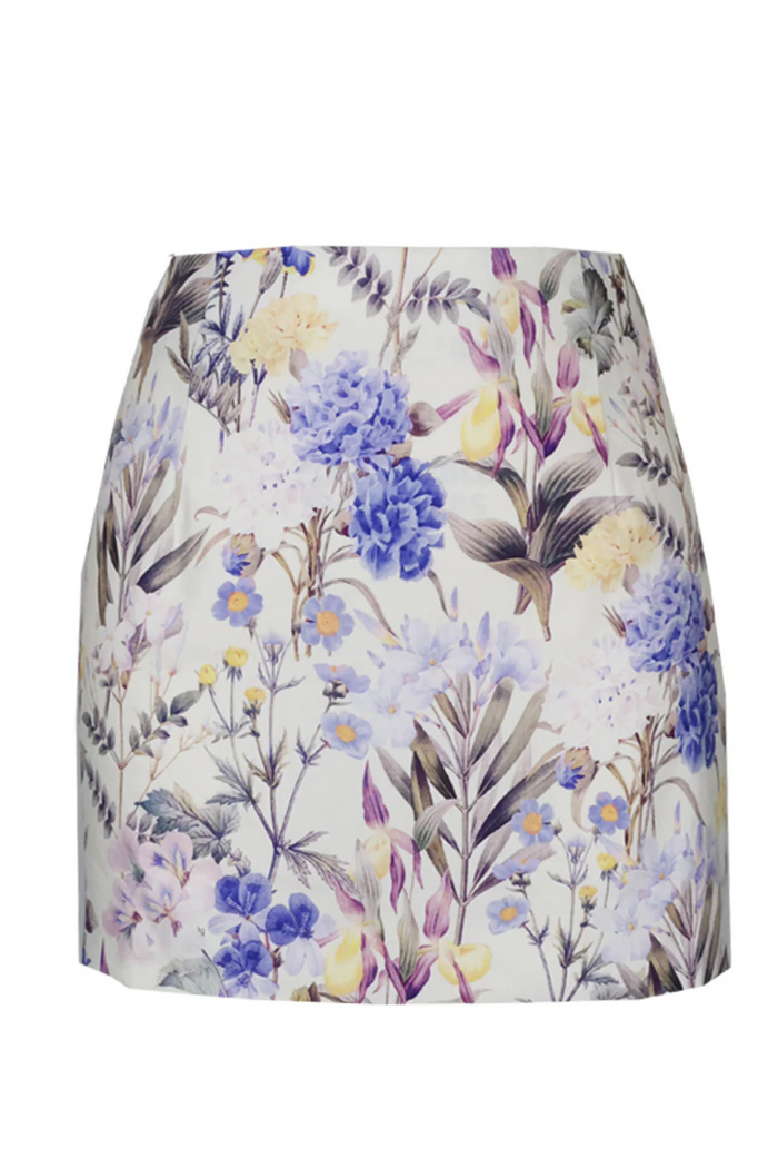 Claudia linen skirt with multicolored botanical floral print in blue, yellow, and purple tones on cream background.