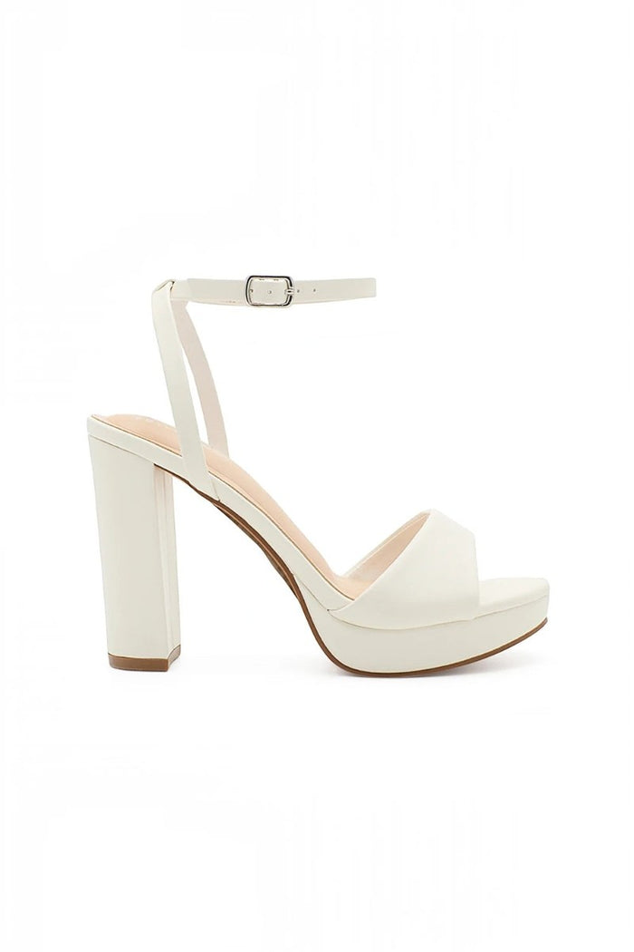 RSG Formals DeBlossom Jane white open-toe platform heels with an adjustable ankle strap and sturdy block heel.