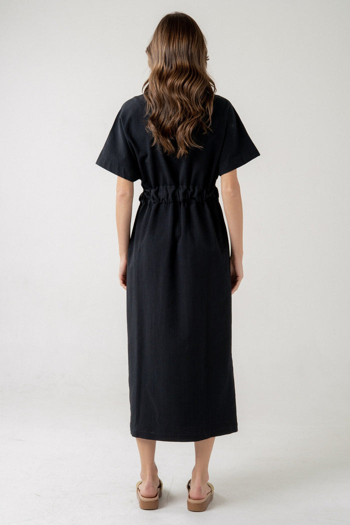 Black midi dress with short sleeves, drawstring waist, and straight silhouette, shown from back view.