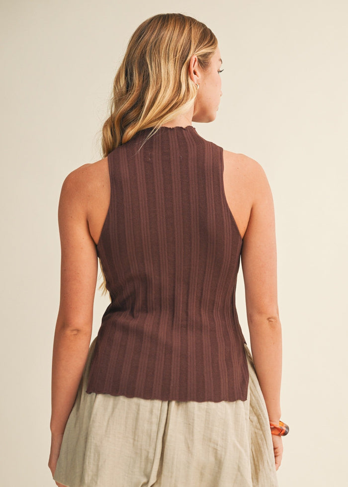 Burgundy ribbed sleeveless top with cream-colored side slit skirt detail, shown on model from back.