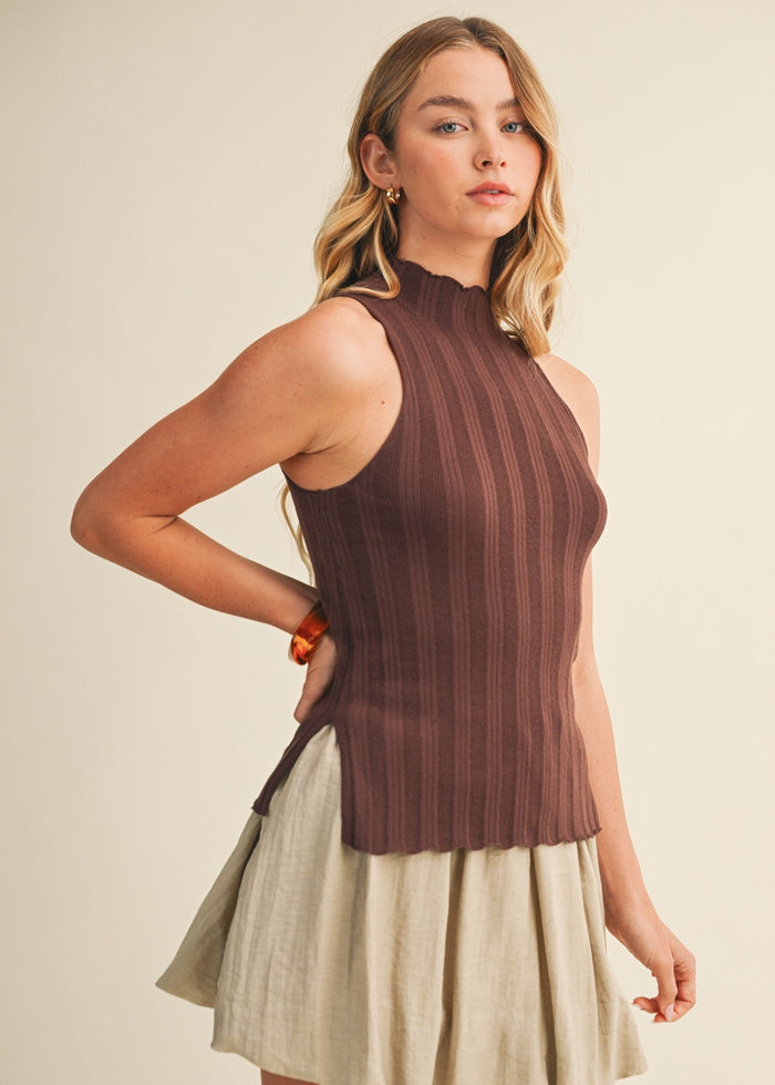 Brown ribbed sleeveless top with side slit, worn with beige skirt.