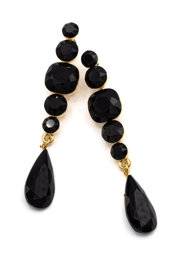 Black beaded earrings with gold backing on a white background