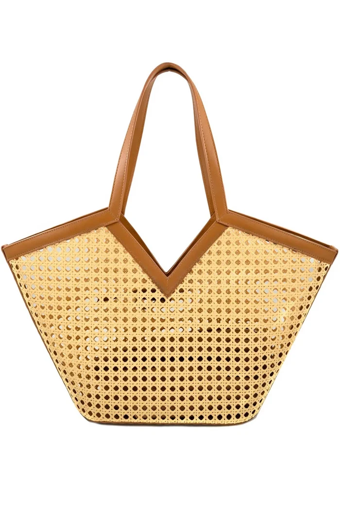 Tan woven tote bag with perforated pattern and cognac leather handles and trim.