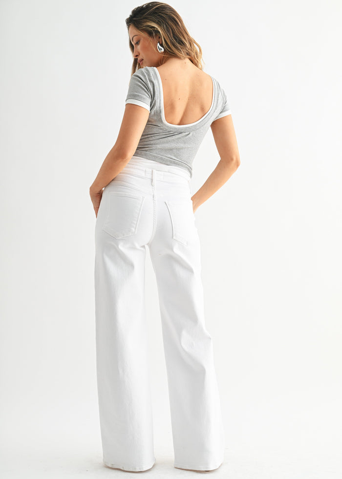 White wide-leg jeans with a high waist and straight leg, styled with a gray short-sleeve top.