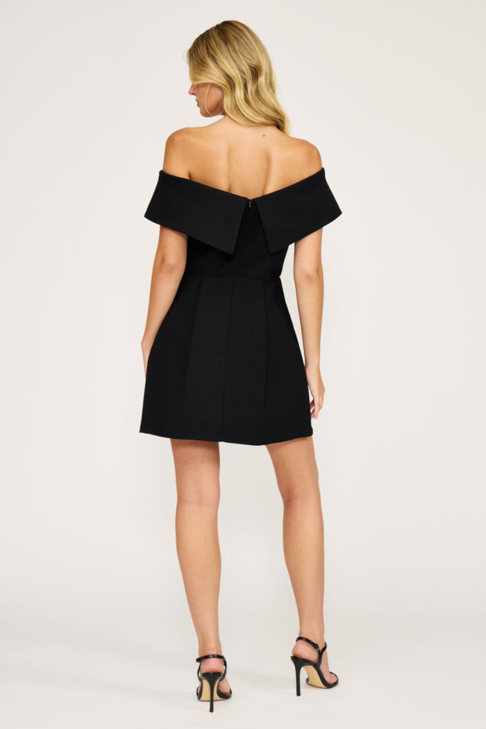 Black off-shoulder mini dress with short sleeves and A-line skirt, shown from back view.