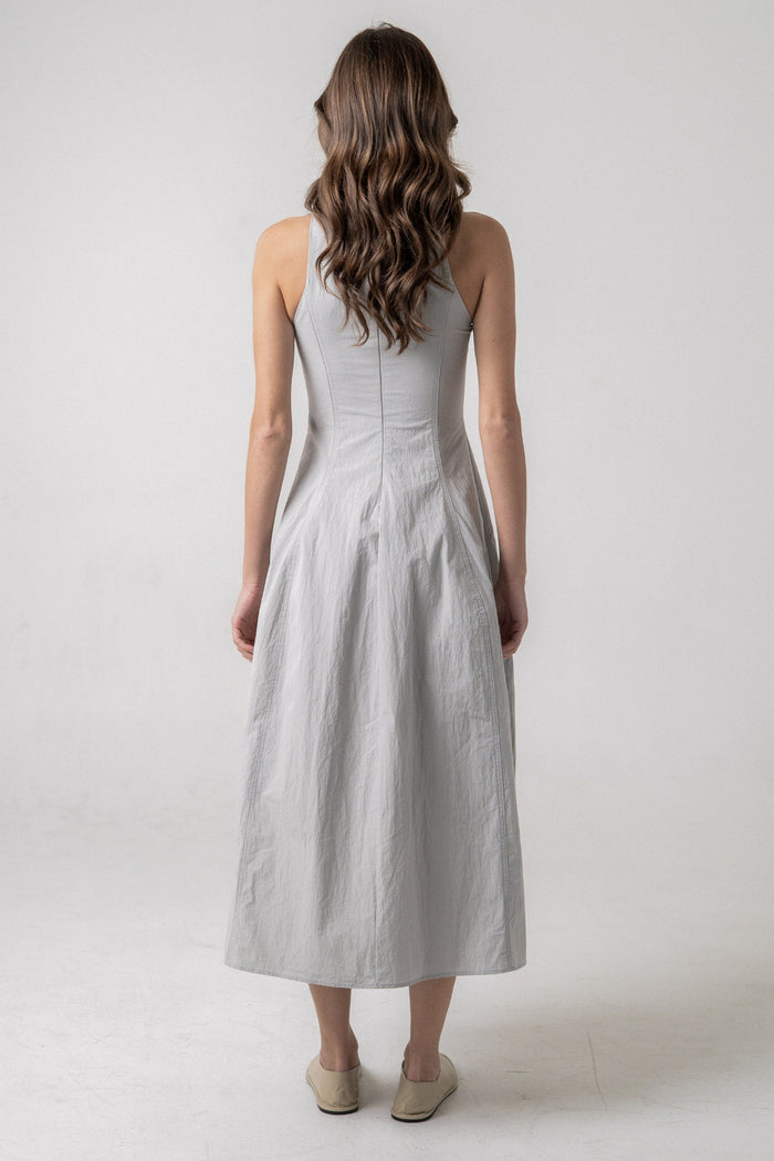 Woman wearing a light gray sleeveless midi dress with a fitted bodice and full skirt, shown from the back.