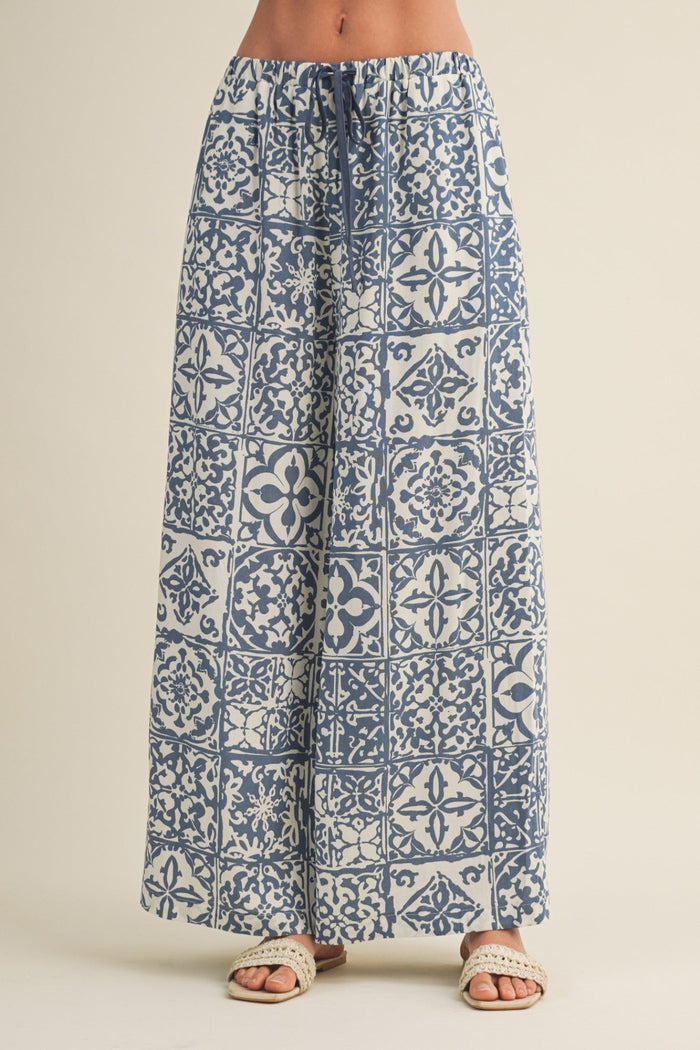Blue and white patterned pants on a beige background