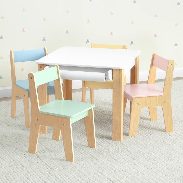 Children's table and chairs set with pastel-colored seats on a light gray floor.