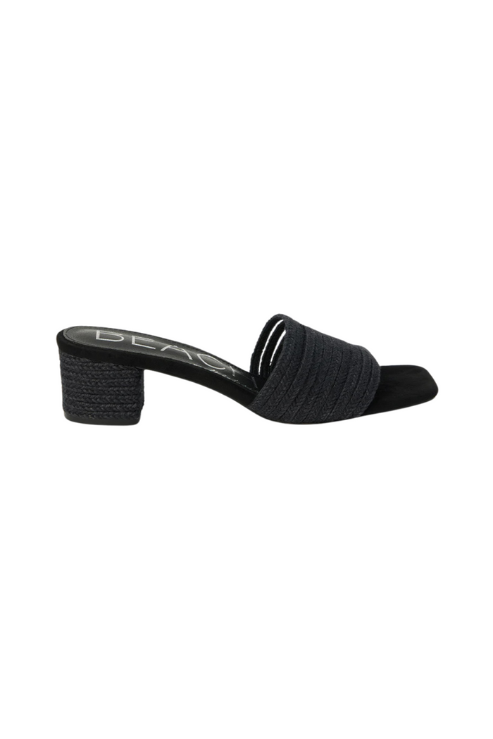 Black mule heel with textured fabric upper and chunky block heel, shown in side profile.