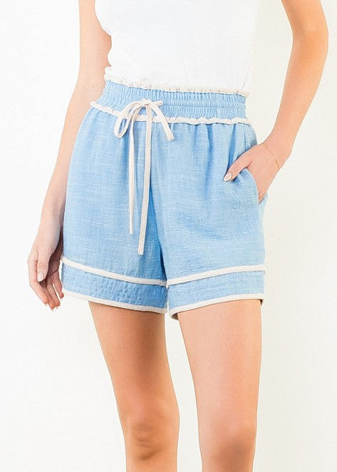 Light blue pull-on shorts with white drawstring waist, side pockets, and contrast trim detail.
