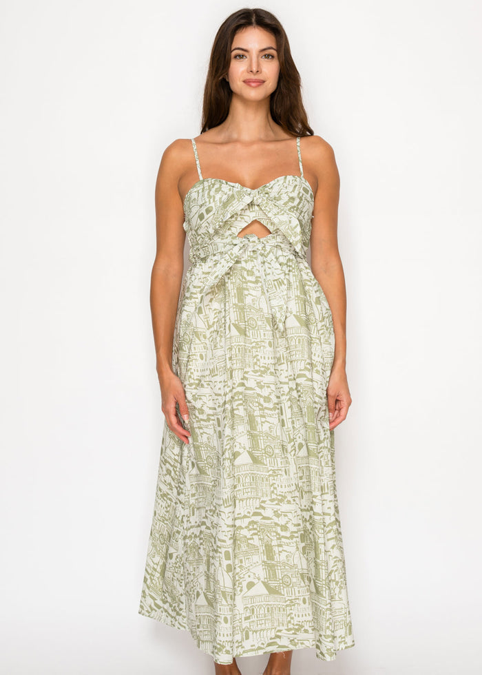 Cream and green architectural print maxi dress with thin straps, sweetheart neckline, and center cutout detail.