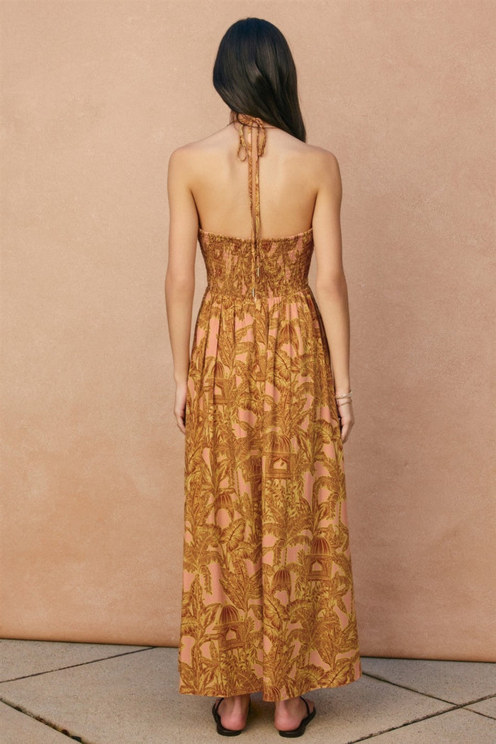 Gold and pink floral print halter maxi dress with smocked bodice, shown from back view.
