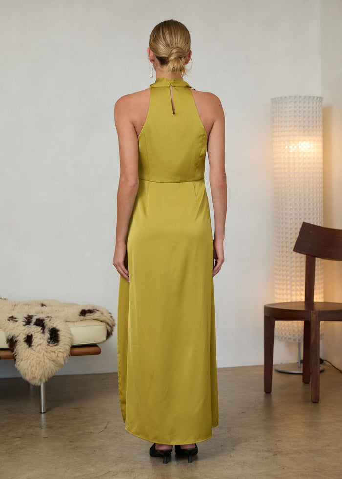 Woman wearing olive-green halter maxi dress with keyhole back detail, shown from behind.