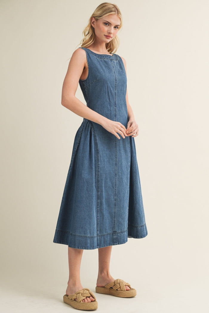 Blue denim sleeveless midi dress with A-line skirt and center seam detail.