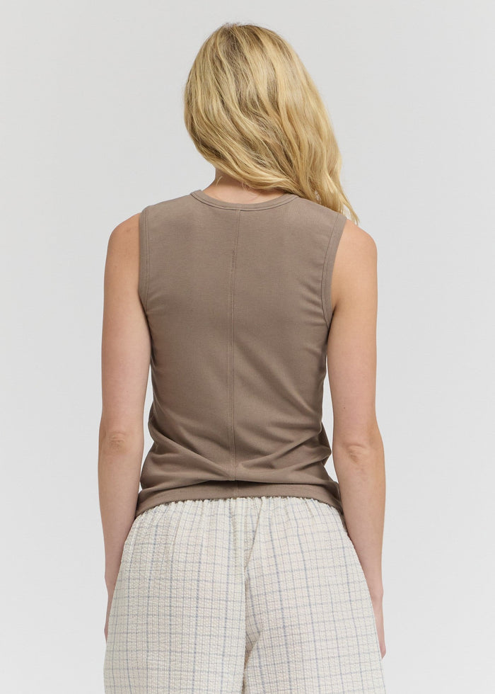 Taupe sleeveless tank top with wide shoulders and center seam, back view on model.