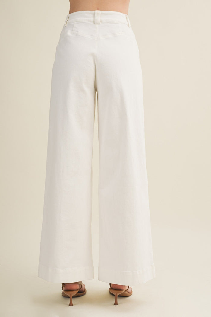 White wide-leg pants on a neutral background