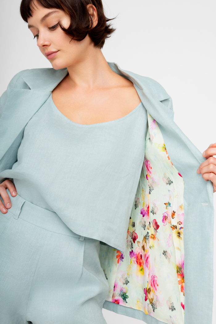 Pale blue sleeveless tank top with scoop neckline worn with matching open shirt jacket featuring floral printed lining.
