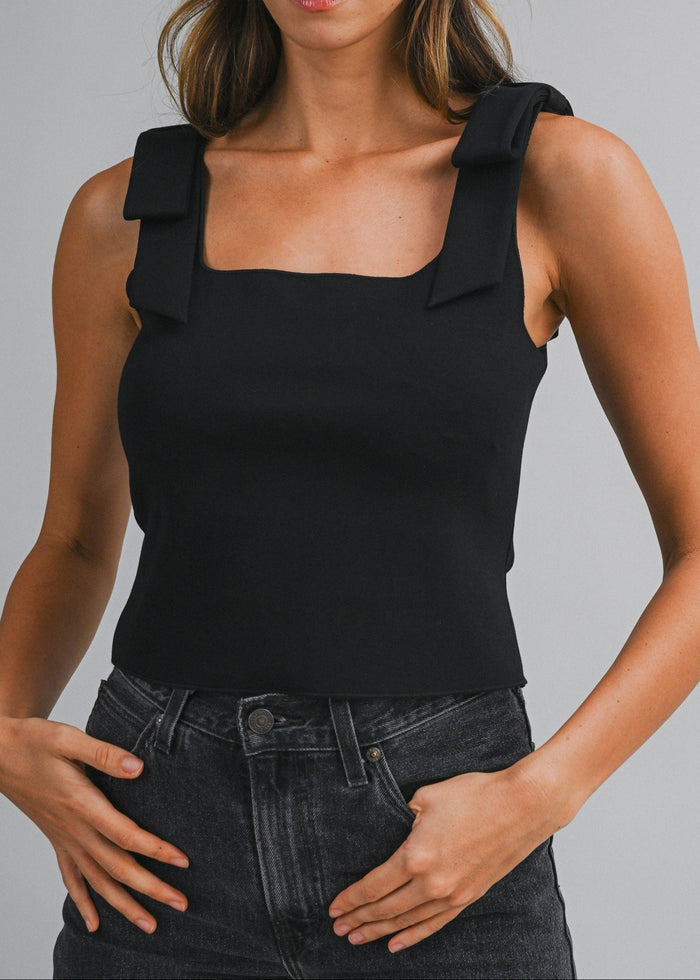 Black sleeveless crop top with square neckline and padded shoulder straps.