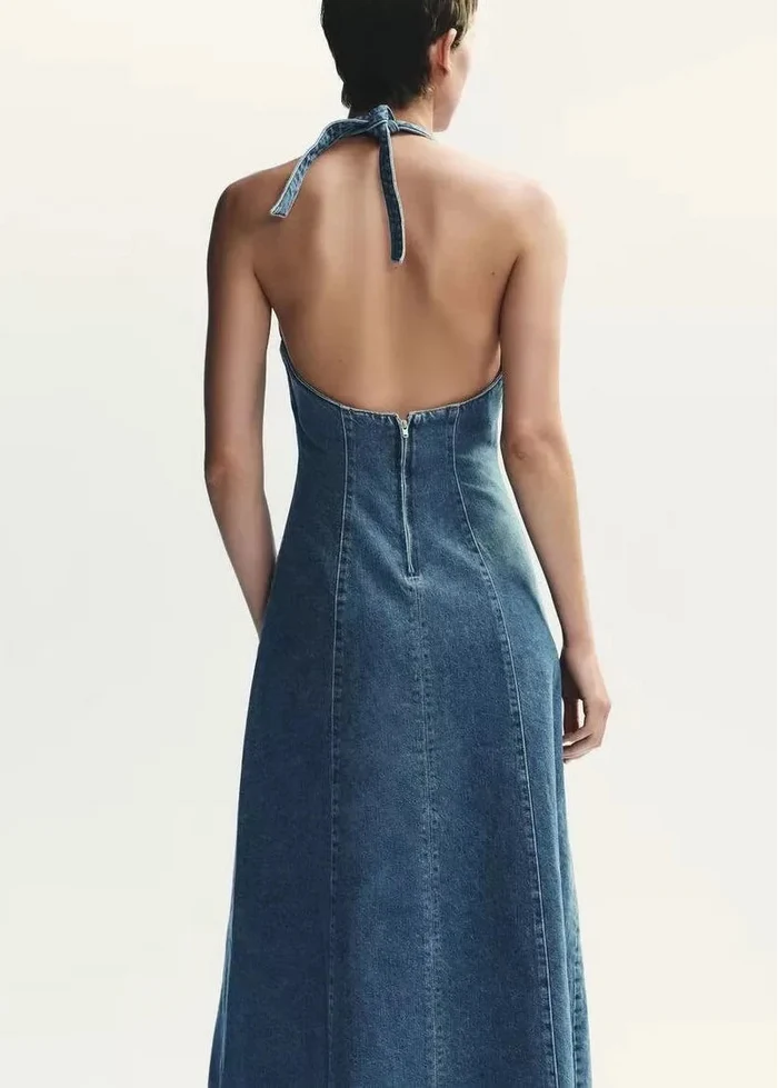 Blue denim halter maxi dress with open back and tie closure at neckline, shown from rear view.